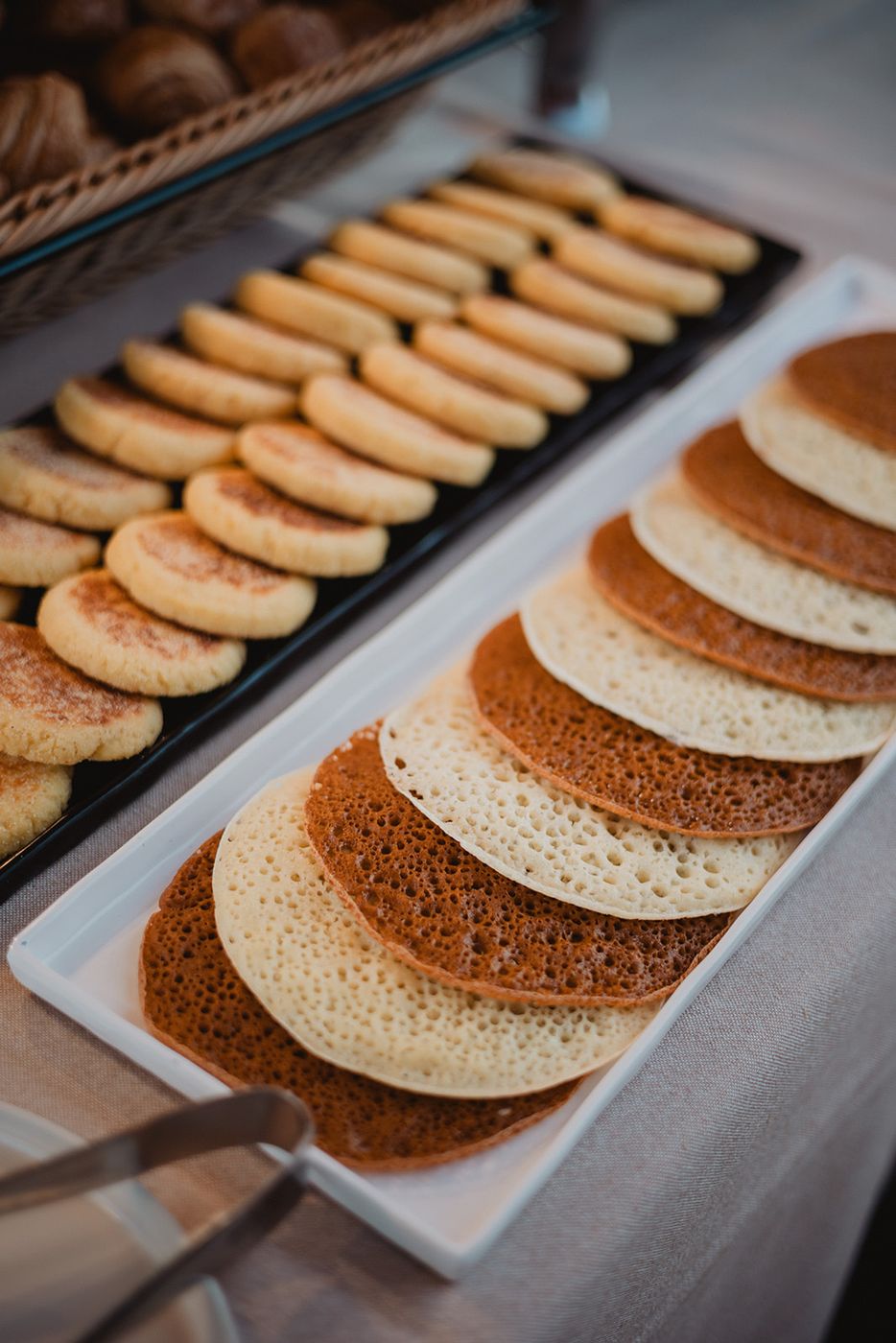 Msemen and baghrir lined up on a white platter