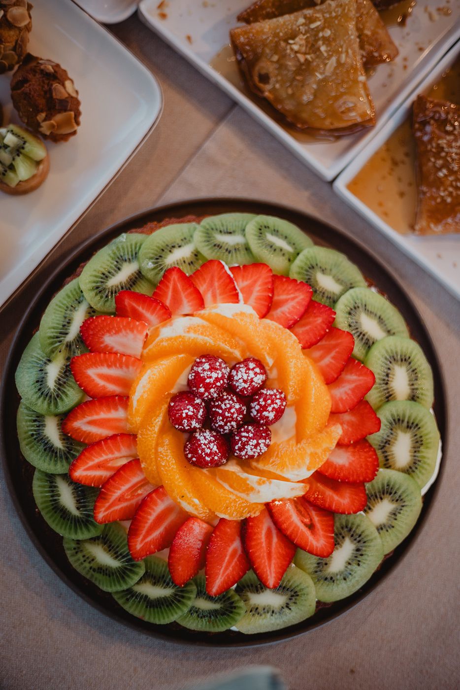 Fruit platter: kiwi, strawberries, oranges, raspberries